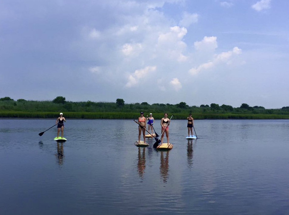 Image of 5 people on paddleboards with SUP Guy Paddle Board Rentals in Cape May NJ